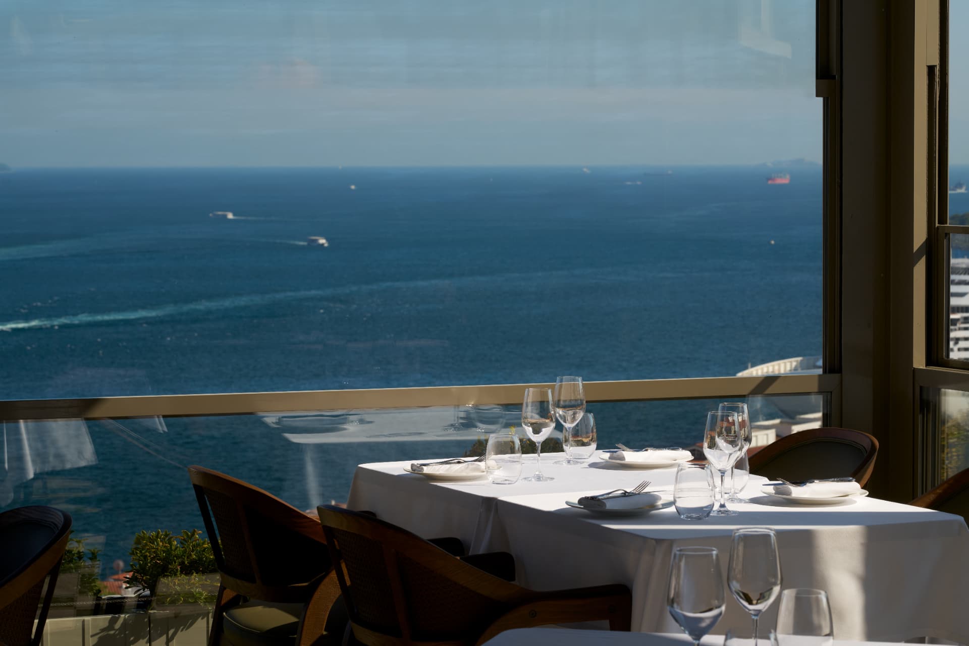 A table set by the window overlooking the sea
